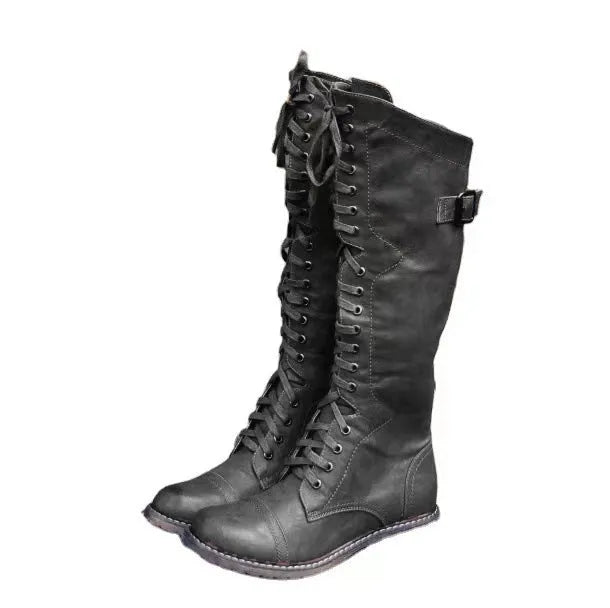 Black chunky heel high leg ankle boots with round toe and low block heel on a plain background.