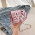 Silver laser pearl tote saddle girl mini crossbody bag with single strap on a mannequin.