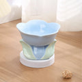 Blue ceramic elevated pet feeding bowl with floral pattern and non-slip base