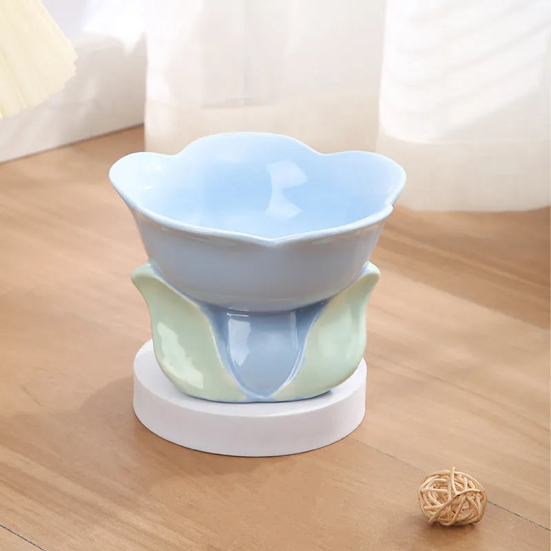 Blue ceramic elevated pet feeding bowl with floral pattern and non-slip base