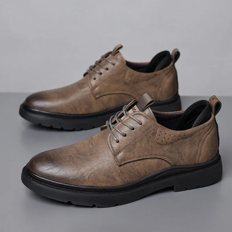 Men's black and brown leather casual sneakers with visible sewing line detail on the cowhide upper.