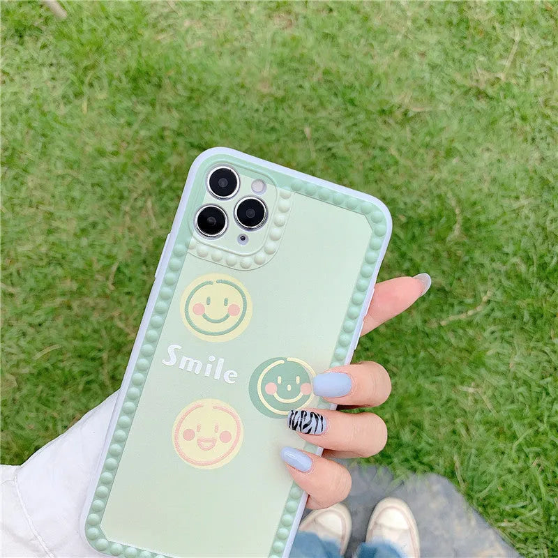 Green iPhone case with smiley face geometric patterns and polka dot frame designs