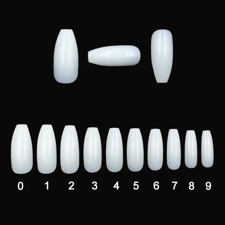 500 clear acrylic false nails in various sizes spread out on a table