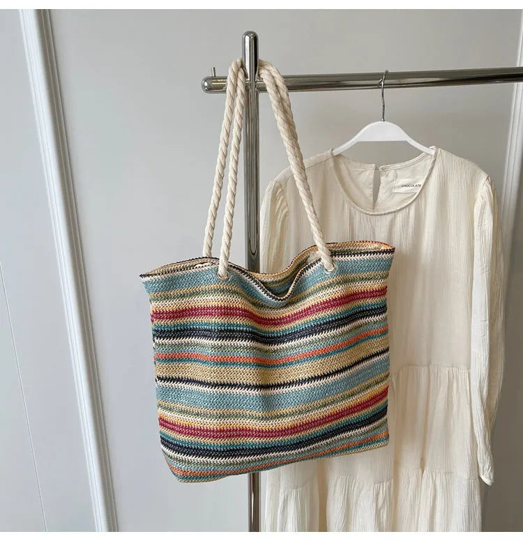 Blue woven straw and nylon shoulder bag with a single strap.