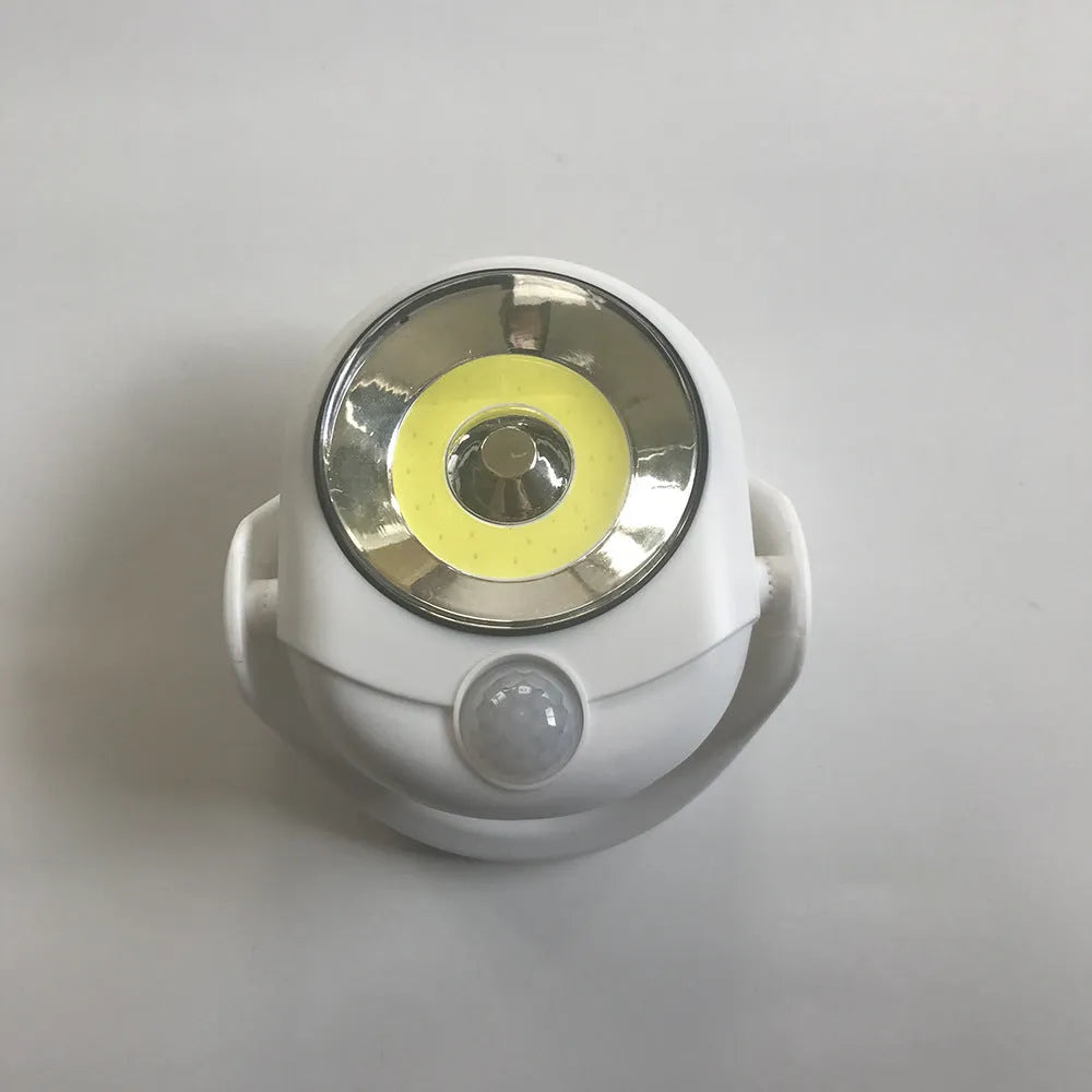 White Atomic Angel induction lamp with ABS plastic housing on a plain background.