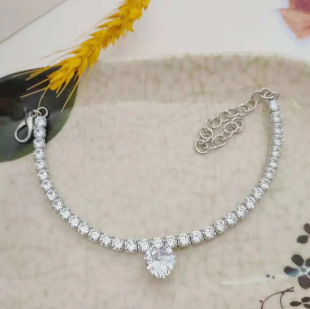 Gold rhinestone heart-shaped decorative collar for a dog with an extension chain.
