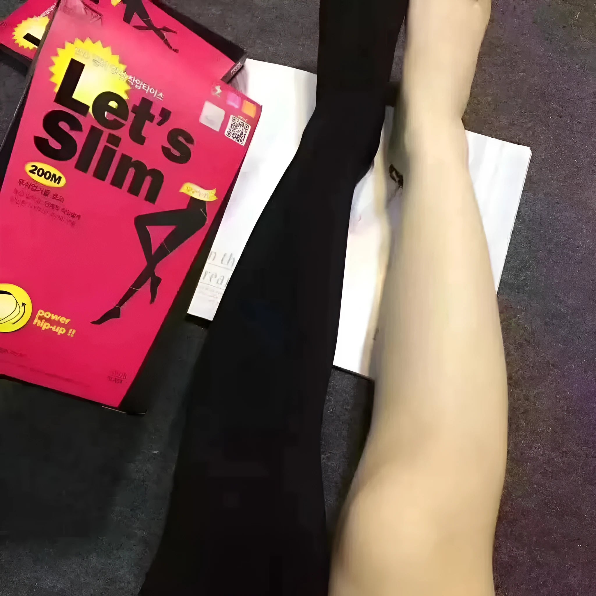 Beige and black stovepipe shapewear socks for lifting hips and abdomen on a plain background.
