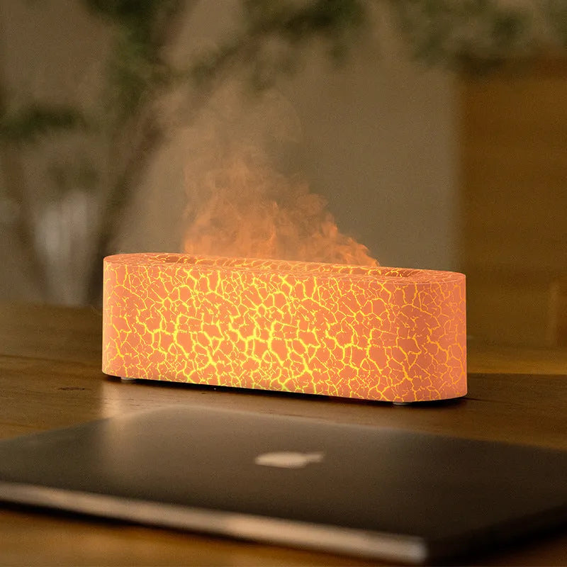 Square-shaped lava lamp-style USB aroma diffuser humidifier with colourful flame light effect on a desk.