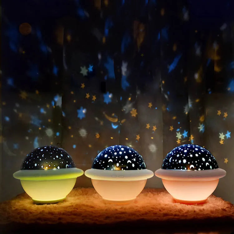 Green UFO-shaped starry sky projection night light with LED lighting on table