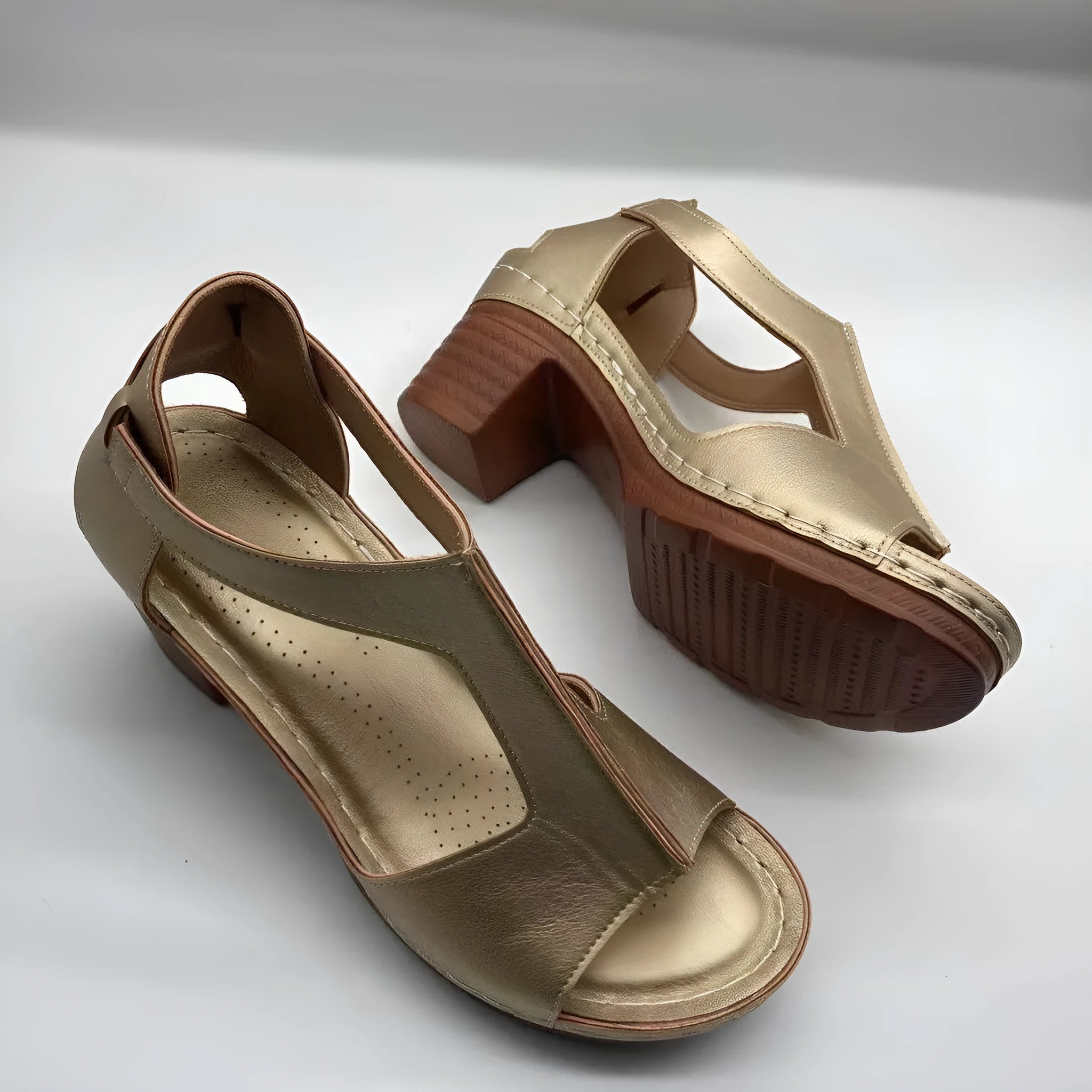 Women's white peep toe wedge sandals with a Roman style fish mouth toe and ankle buckle on a low rubber sole.