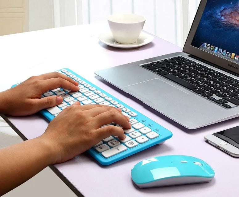 Wireless keyboard and mouse set in choice of colours on a desk, showing USB receiver.