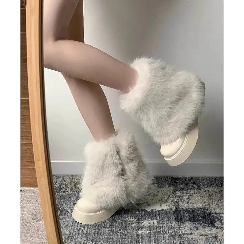 Women's black fleece-lined low-top snow boots with a round toe, waterproof platform, and a mid-height heel on a rubber sole.
