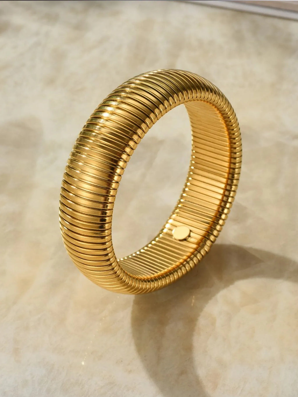 Gold titanium steel bracelet with elastic band and exaggerated vertical stripe ring design