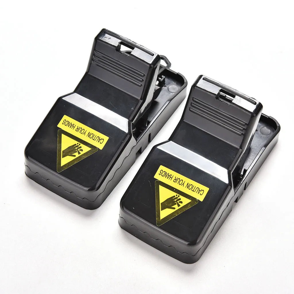 Six black plastic snapping mouse traps showing dimensions and smooth surface