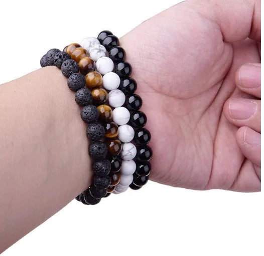 Geometric black agate beaded bracelet with 8mm stones on a black elastic cord.