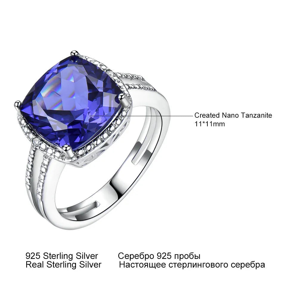 Blue Tanzanite stone set in a sterling silver 925 ring for women, shown on a finger.