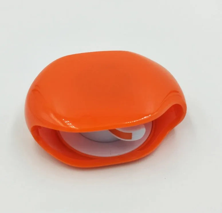 Automatic earphone cable retractor winder in a compact plastic storage box.