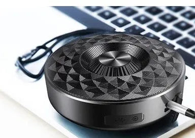 Compact circular black wireless Bluetooth sound box with multi-colour LED lights around its edge.