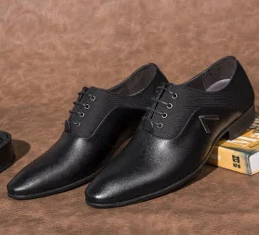Men's black Oxford shoe with a low upper and rubber sole on a white background.