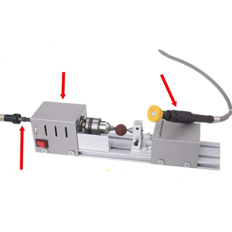 Compact silver metal mini manual woodworking lathe with carving knives on a benchtop