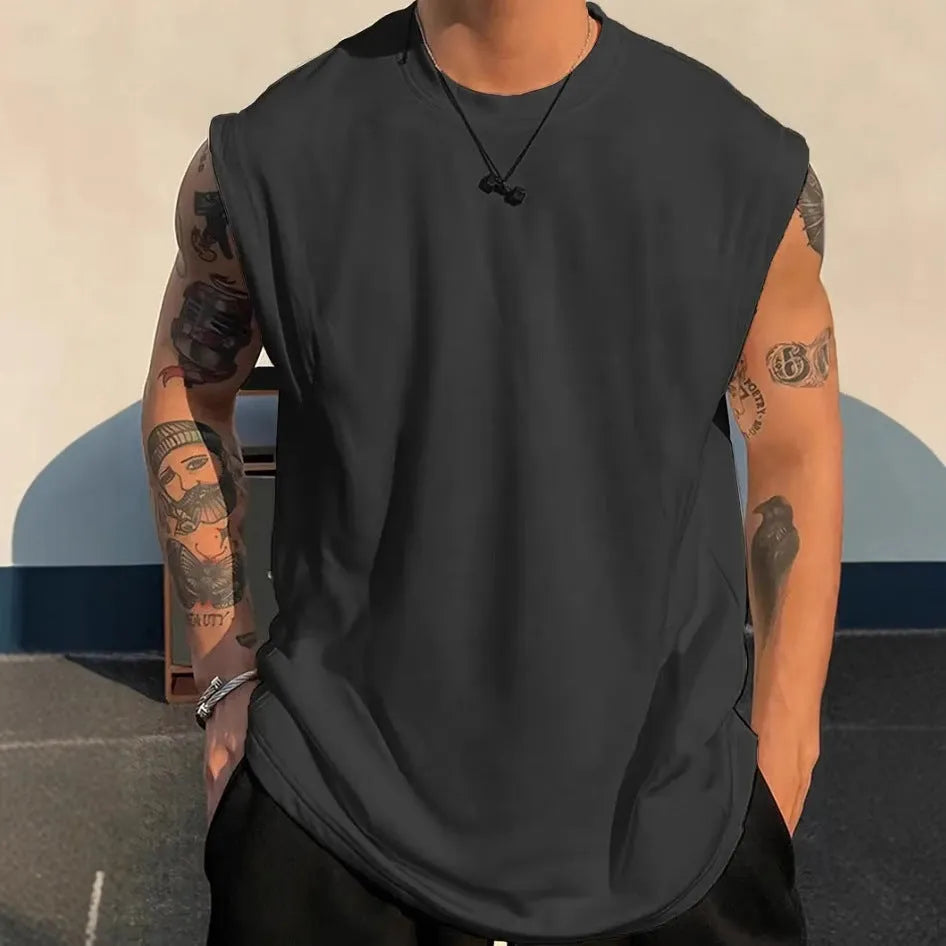 Man wearing a loose solid-colour cotton sleeveless pullover tank top.