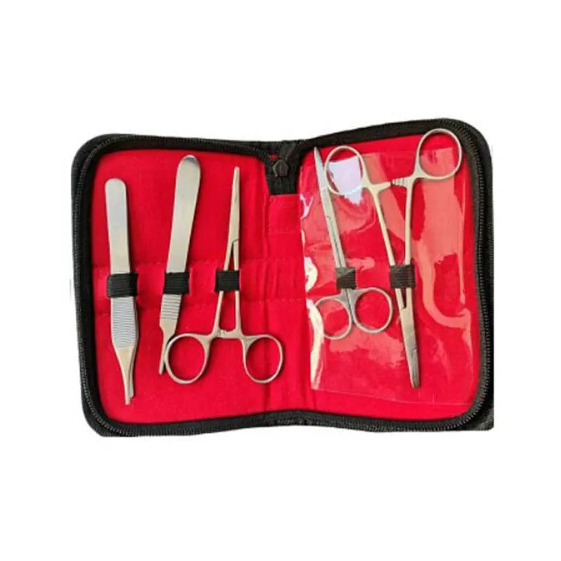 Medical student training kit with black silicone suture pad, tools, and multi-wound block on a table
