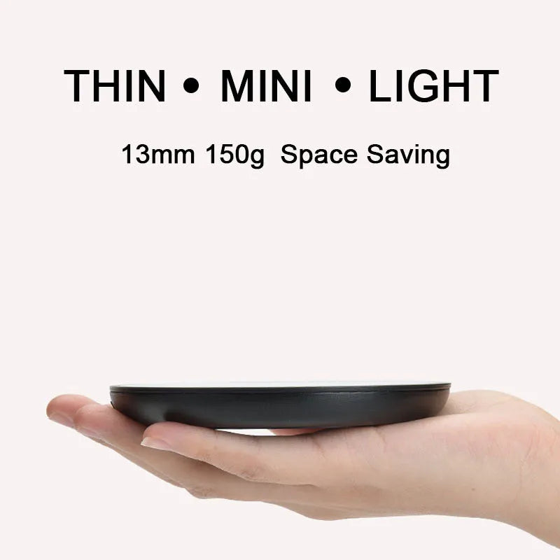 Black dual-temperature coffee mug warmer with low/high switch on a desk.