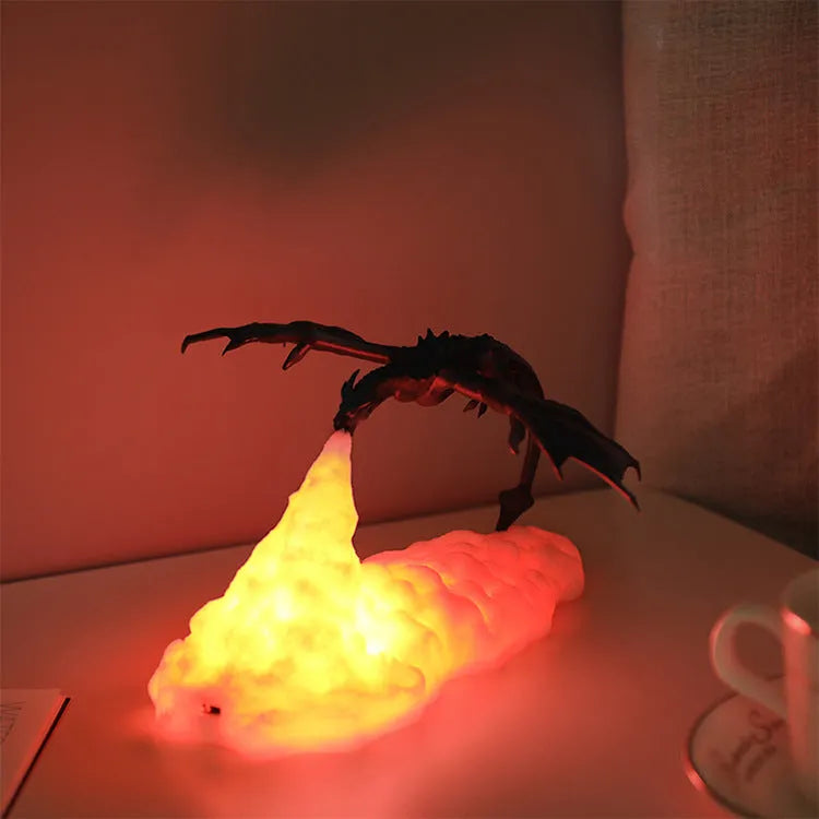 3D printed red dragon night light glowing on a surface with USB charging cable