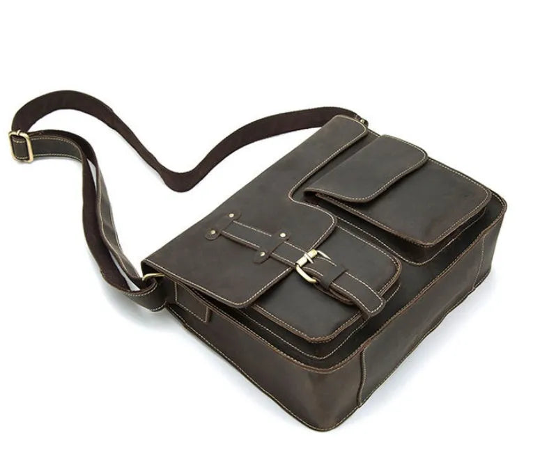 Vintage brown leather messenger bag with antique brass buckle and crossbody strap