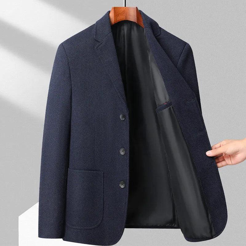 A man wearing a solid colour loose-fit wool blend coat suitable for spring or autumn.