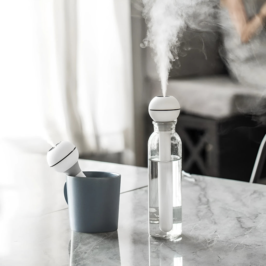 Pink and white columnar magic wand humidifier with USB cable and 1 litre water tank.