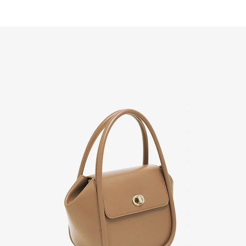 Women's leather wing tote handbag with cross-body strap and hard handle in cow leather