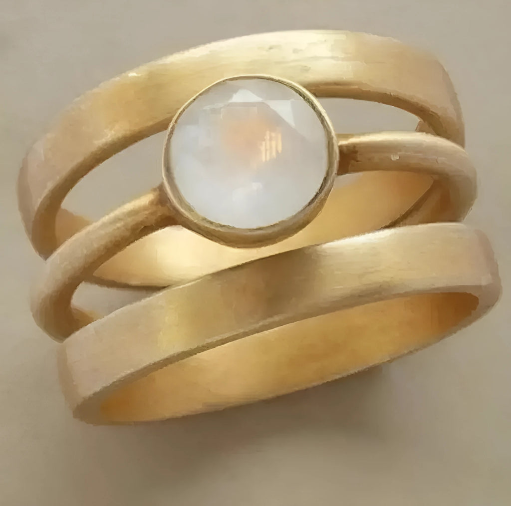 Gold plated geometric titanium steel ring with micro-inlaid white chalcedony detail showing linear design elements