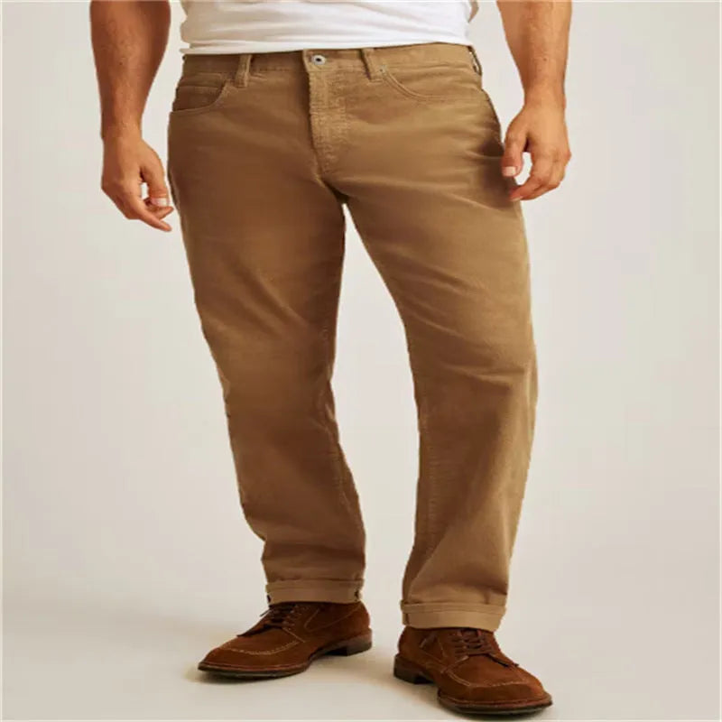Corduroy straight-leg trousers in green displayed flat showing mid-waist design and zip fly