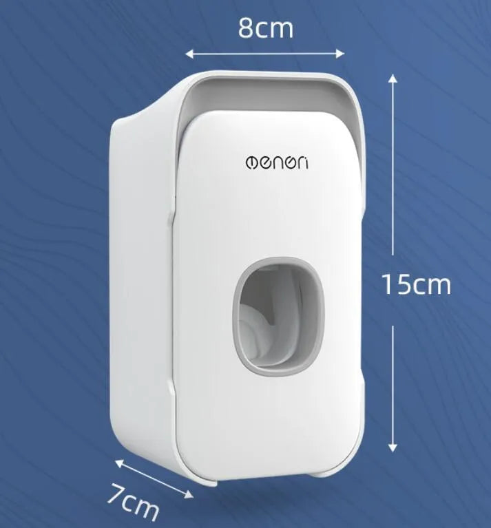 Blue automatic toothpaste dispenser mounted on a bathroom wall with a toothbrush below.