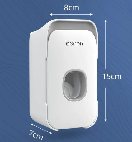 Blue automatic toothpaste dispenser mounted on a bathroom wall with a toothbrush below.