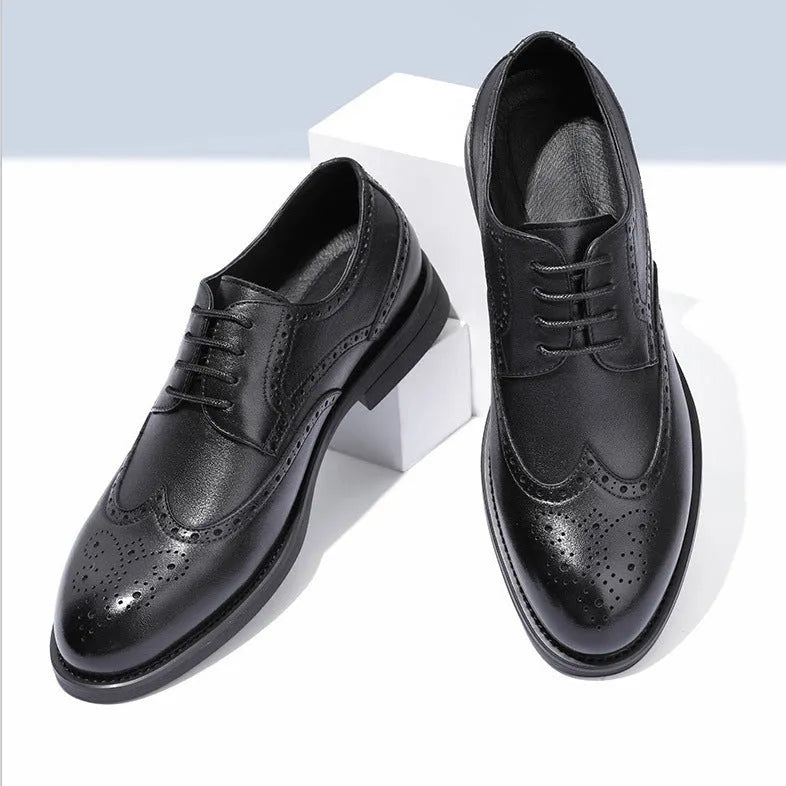Men's black and brown brogue leather shoes with decorative perforations, shown on a white background.