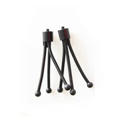 Small black iron mini tripod with ball head extended, next to an iPhone on a desk
