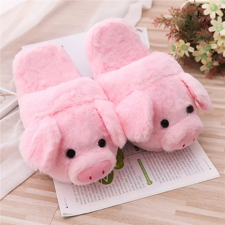 Pink pig-shaped floor slippers with short plush fabric on a plain background.