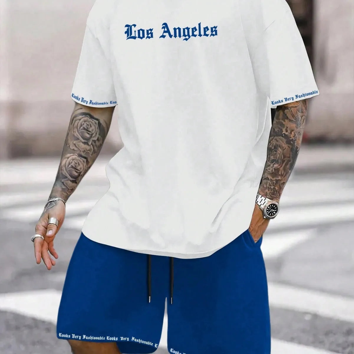 Sports style short-sleeved top and matching shorts set laid flat, showing thin polyester blend fabric.