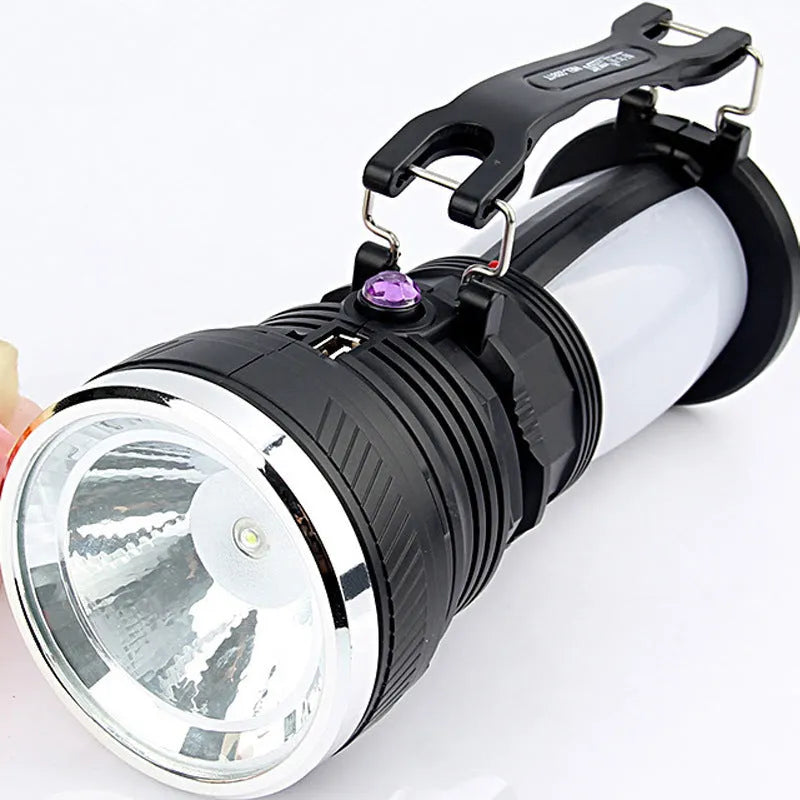 Black solar-powered LED emergency flashlight with USB charging port shown on a textured background.