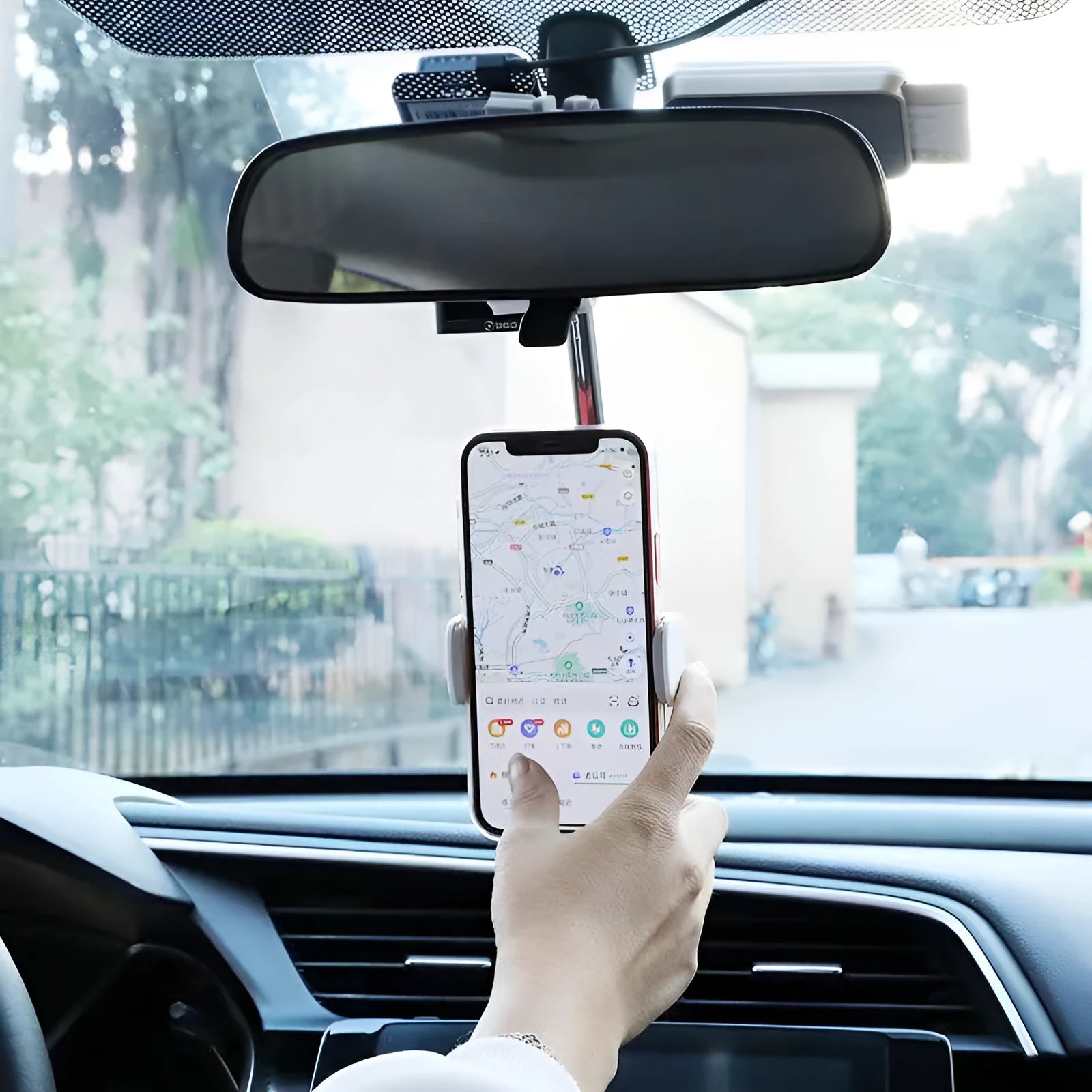 Black ABS plastic mobile phone bracket mounted on car rearview mirror holding a smartphone