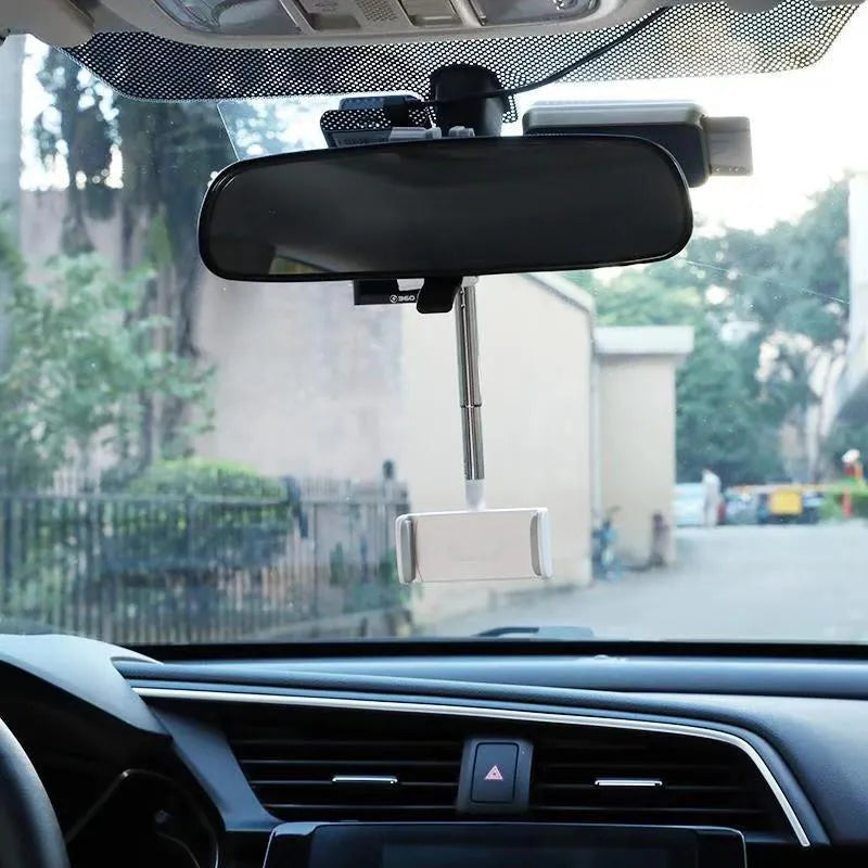 Black ABS plastic mobile phone bracket mounted on car rearview mirror holding a smartphone