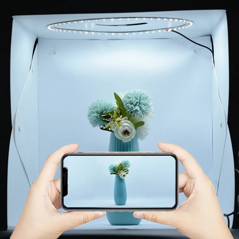 40cm folding studio LED soft light box with adjustable colour temperature and six colourful background cloths laid out.