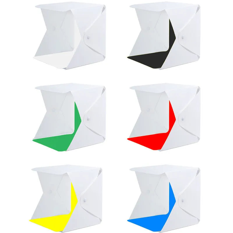 40cm folding studio LED soft light box with adjustable colour temperature and six colourful background cloths laid out.