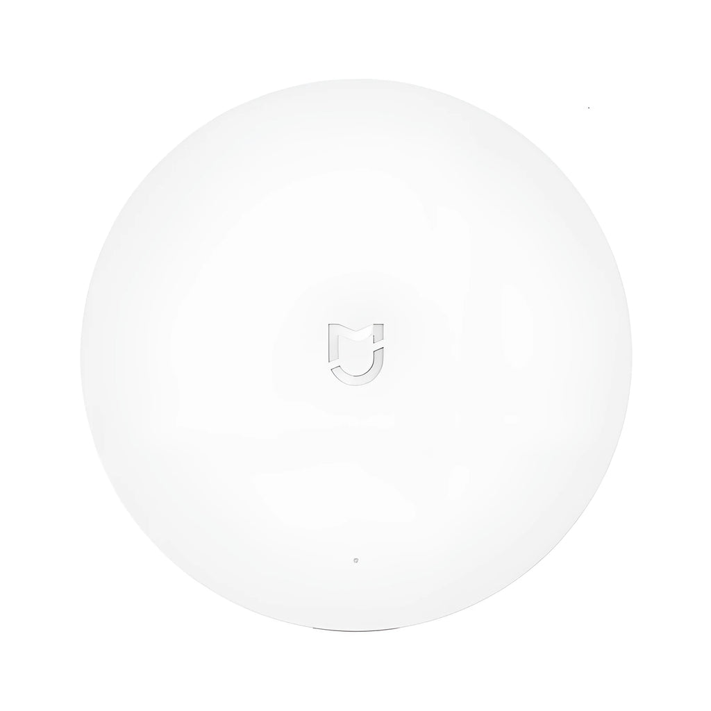 White circular Xiaomijia smart home gateway with UK plug for wall mounting.