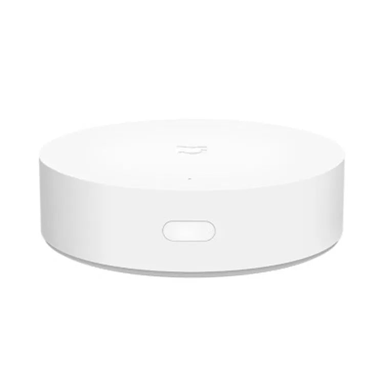 White circular Xiaomijia smart home gateway with UK plug for wall mounting.