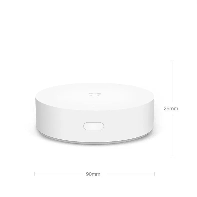 White circular Xiaomijia smart home gateway with UK plug for wall mounting.