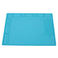 Blue silicone anti-skid pad for watch repair on a workbench, showing non-slip surface