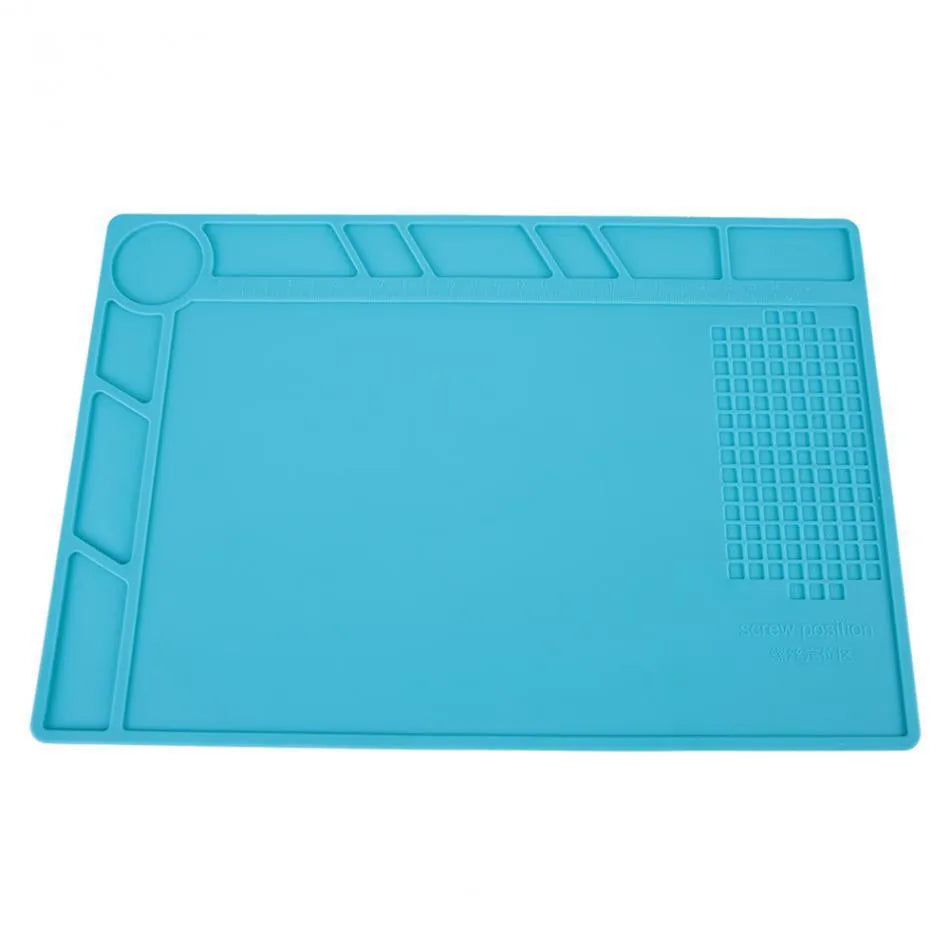 Blue silicone anti-skid pad for watch repair on a workbench, showing non-slip surface